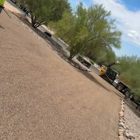 Chip-seal equipment applying aggregate across a prepared Arizona surface